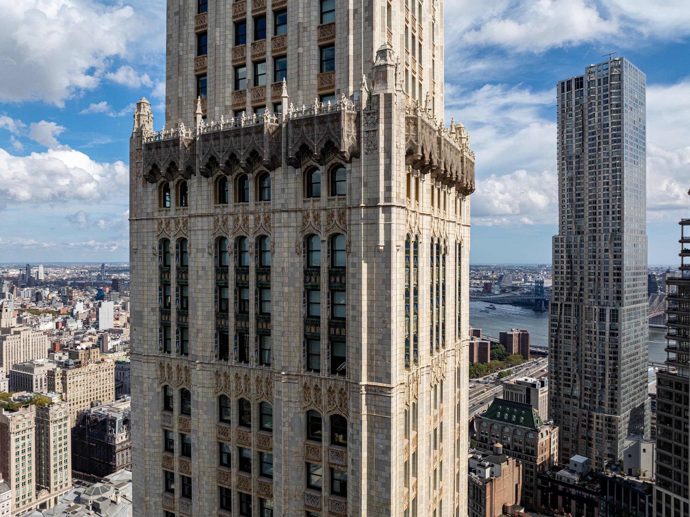 The restored Gothic crown of the Woolworth Building above Lower Manhattan and the East River